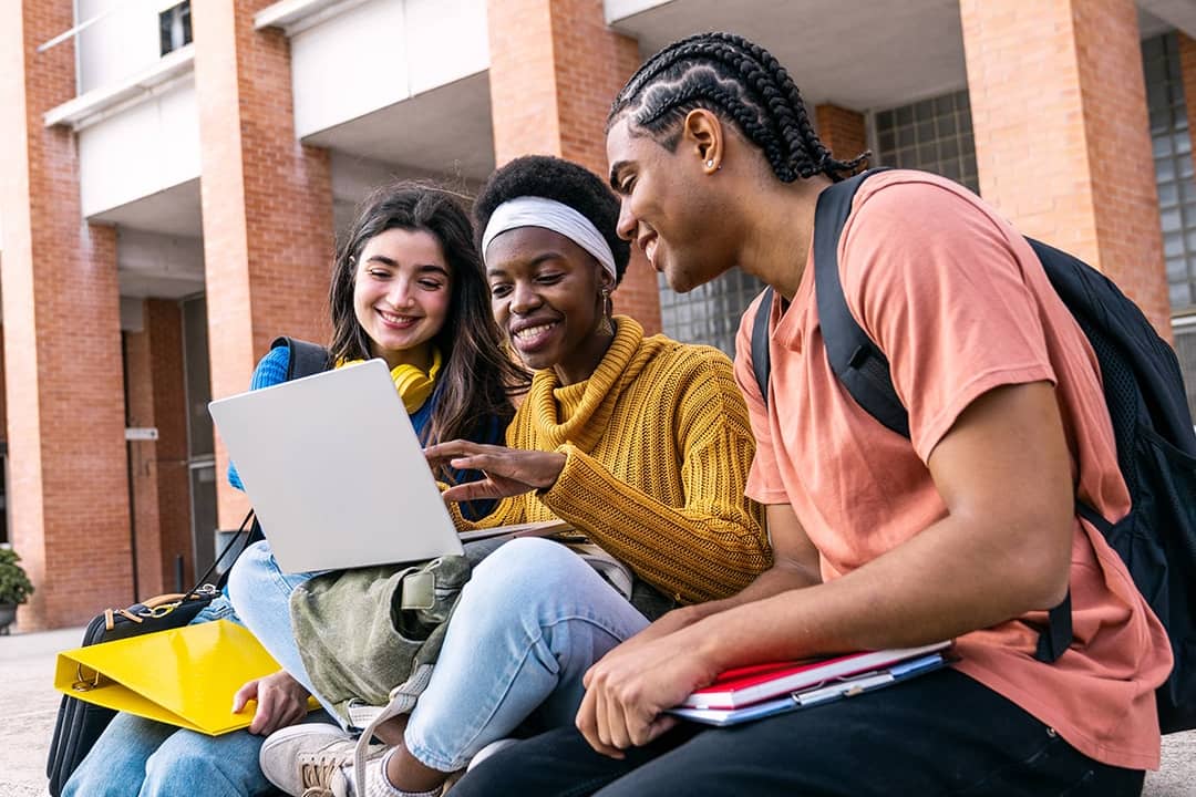 A group of college students collaborating outdoors.